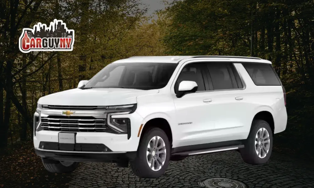A white Chevrolet Suburban SUV parked on a cobblestone path, with trees in the background and a "Carguyny" logo in the corner.
