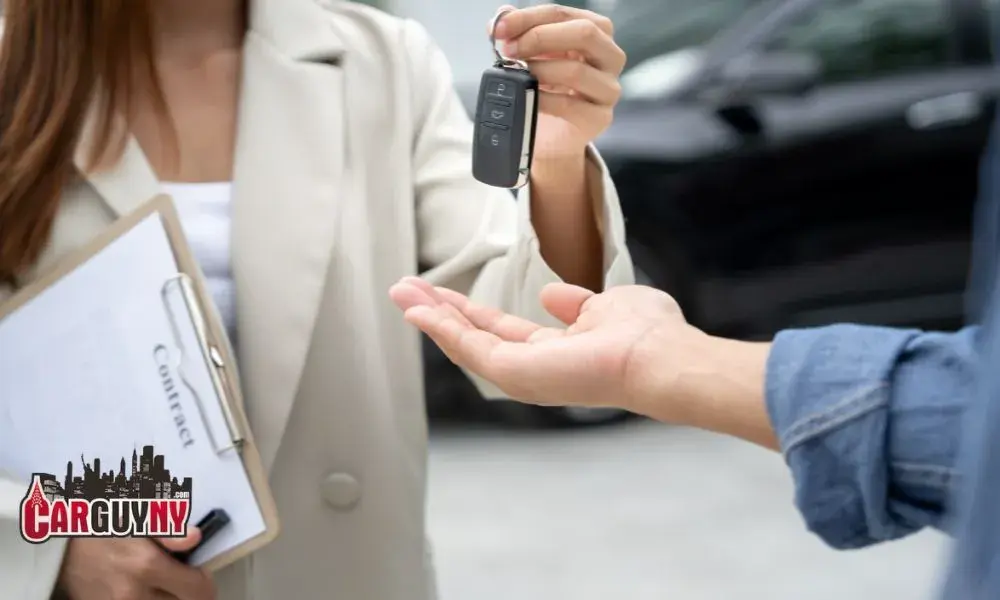 A person hands over car keys to another, with a clipboard labeled "Contract" in the background.